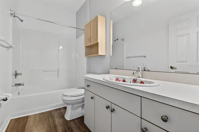 a bathroom with a sink toilet vanity and tub