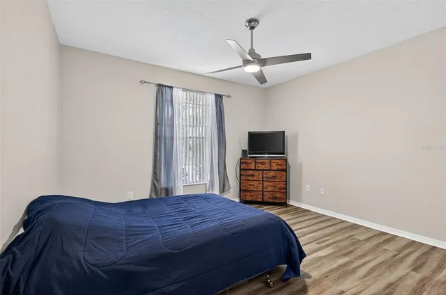 a bedroom with a bed and a television