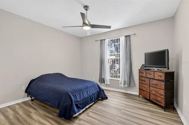 a bedroom with a bed and flat screen tv