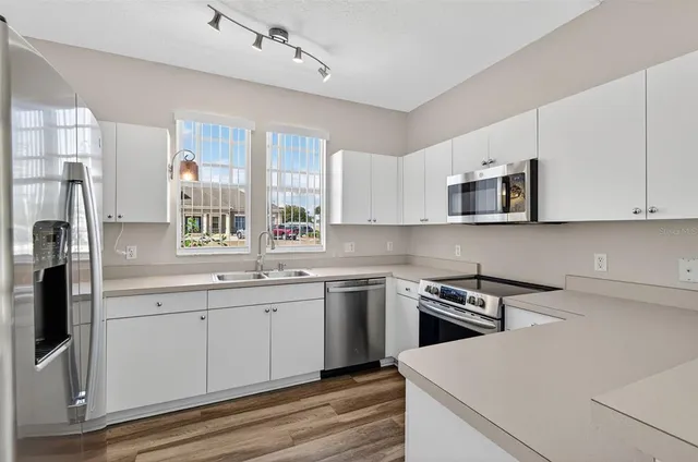 a kitchen that has a sink and a stove in it