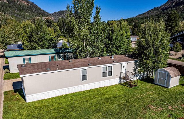 an aerial view of a house with a yard