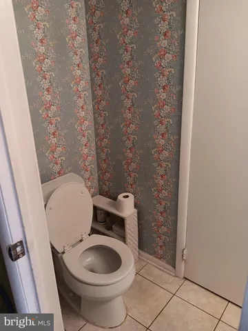 a white toilet sitting next to a small sink