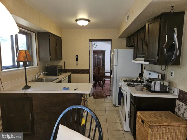 a kitchen with a sink stove and refrigerator