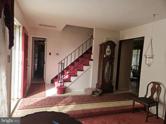 a living room with lots of furniture and a potted plant