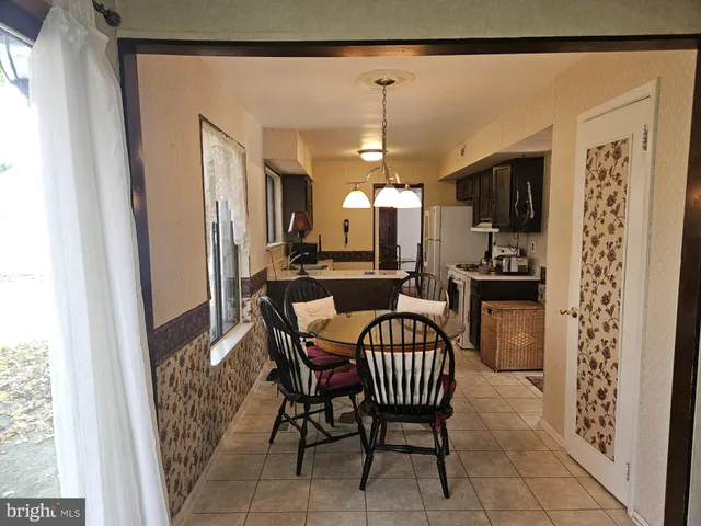 a view of a dining room with furniture and a chandelier