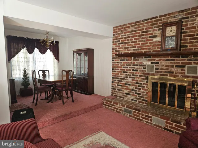 a view of a livingroom with furniture and a fireplace