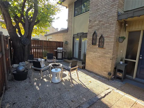 a view of a chairs and table in the back yard of the house