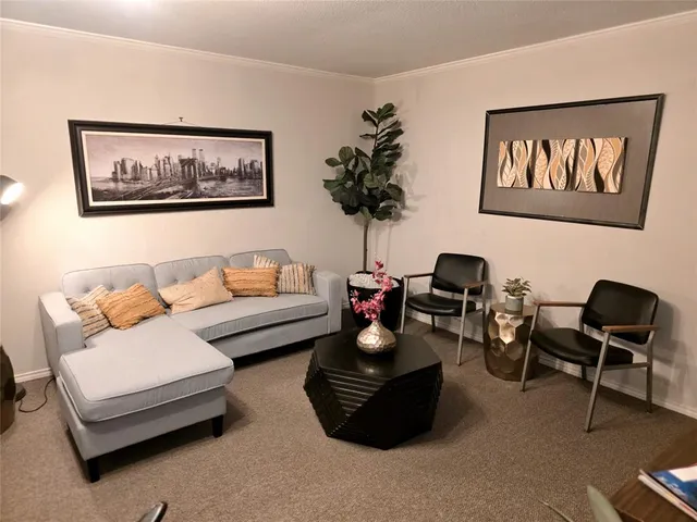 a living room with furniture and a bookshelf