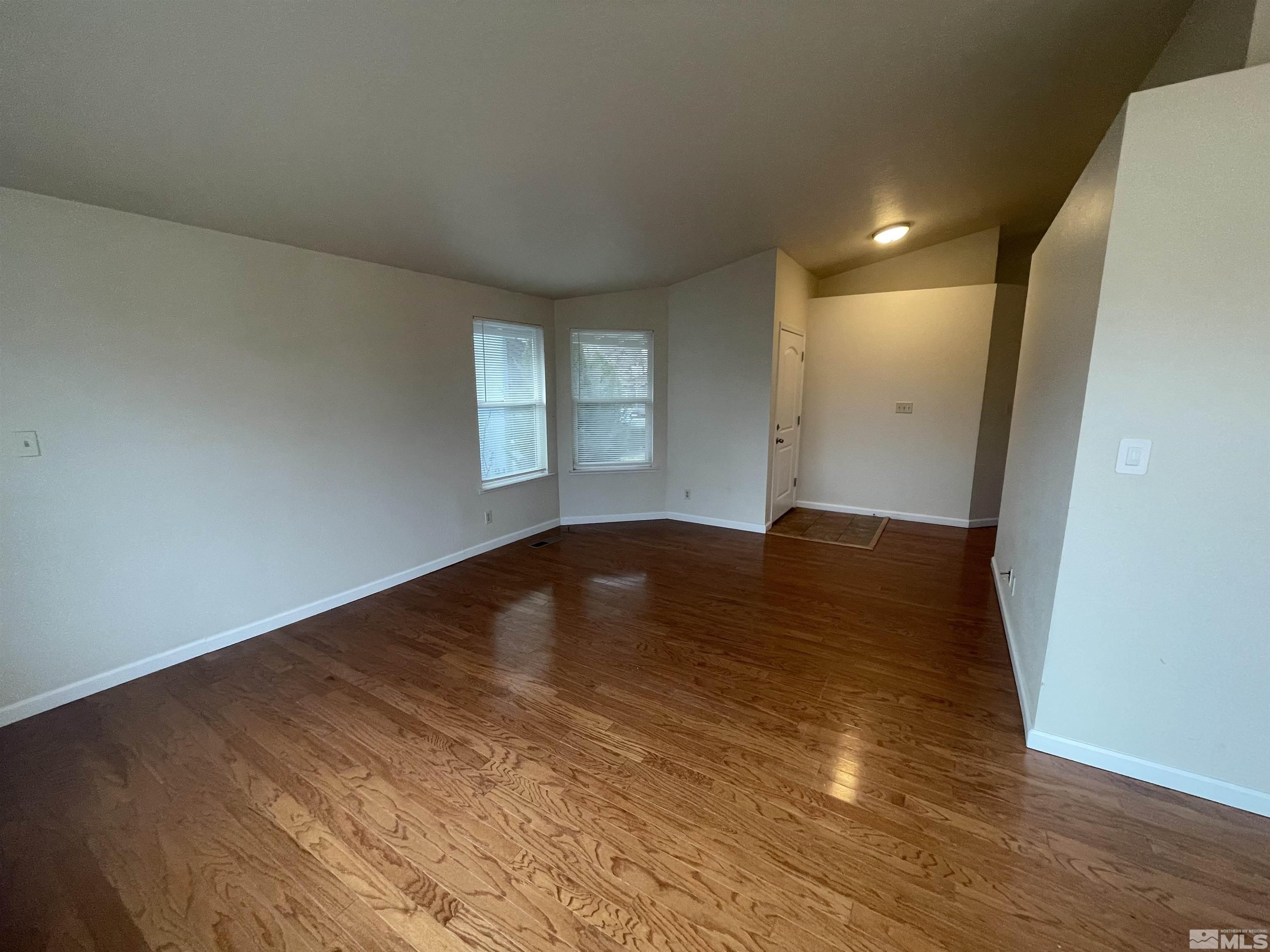 1356 Canyon Creek Road Reno, NV 89523 - Photo 4 of 16 an empty room with wooden floor and windows