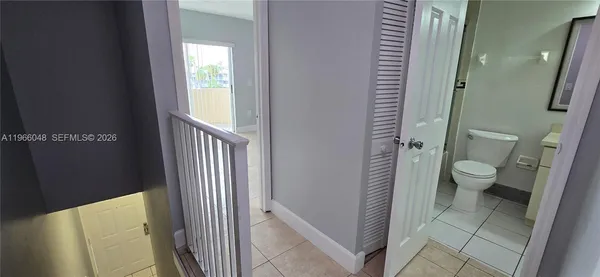a bathroom with a granite countertop shower and a toilet
