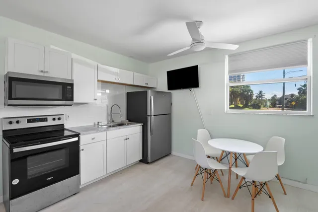 a kitchen with a stove a sink and a microwave