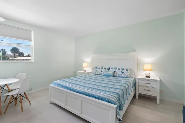 a bedroom with a bed and a chair