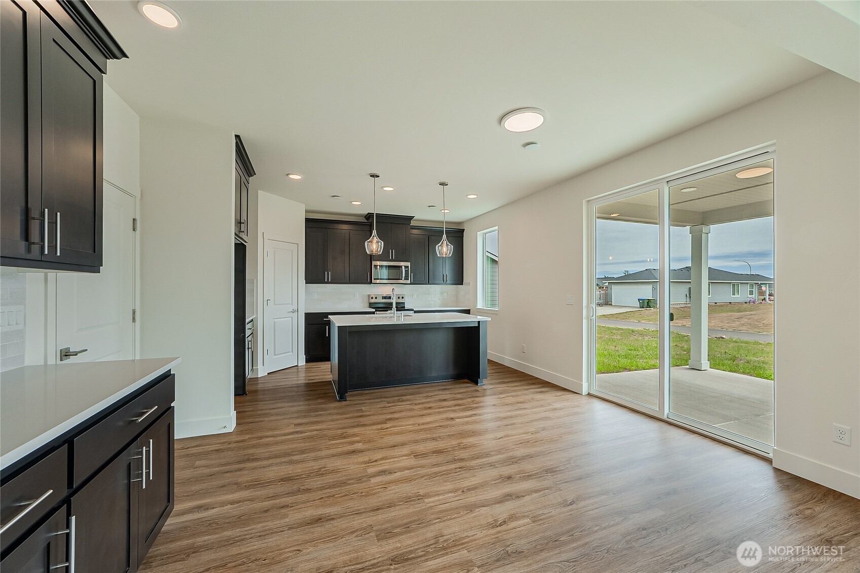 404 Pagget Avenue Winlock, WA 98596 - Photo 10 of 40 a view of kitchen with granite countertop a sink and a stove top oven