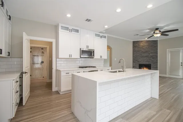 a kitchen with a sink stove and refrigerator