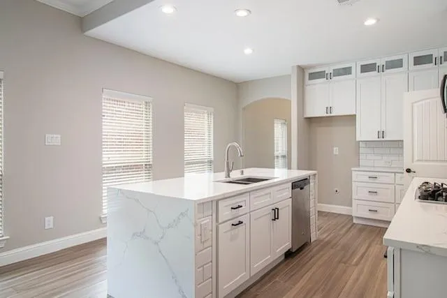 a kitchen with a sink stove and cabinets