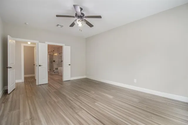 a view of an empty room and wooden floor