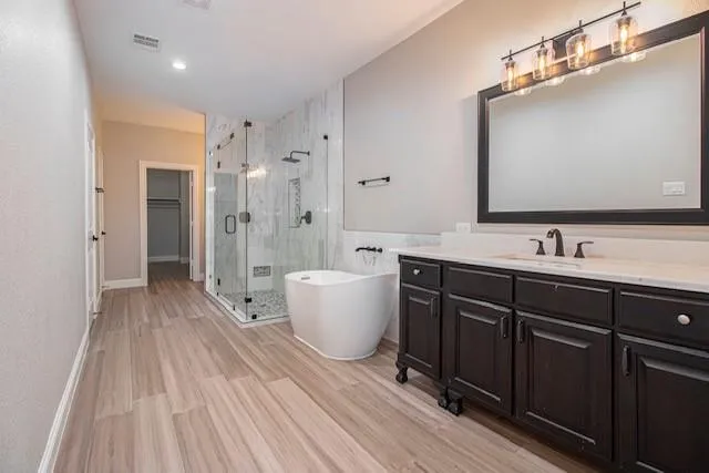 a spacious bathroom with a double vanity sink a large mirror and a shower