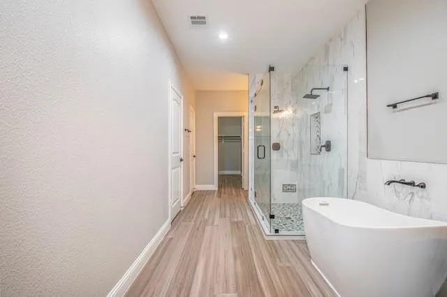 a view of a bathroom with a bathtub and shower