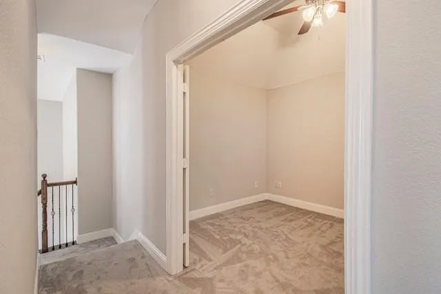 an empty room with a empty space and a ceiling fan