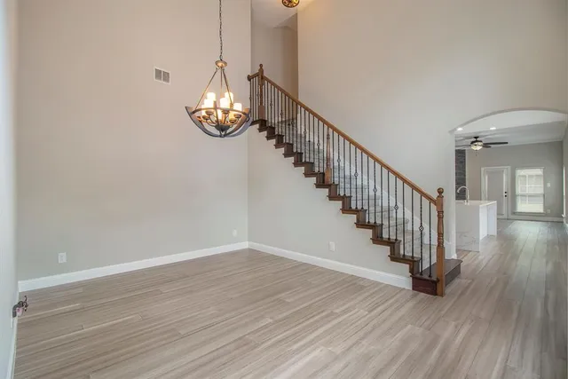 a view of entryway and hall with wooden floor