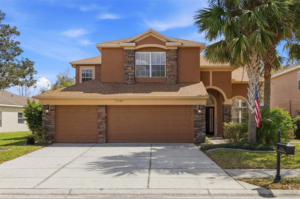a front view of a house with a yard and garage