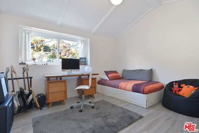 a living room with furniture a window and a flat screen tv