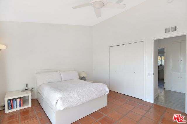 a bedroom with a bed and a book shelf