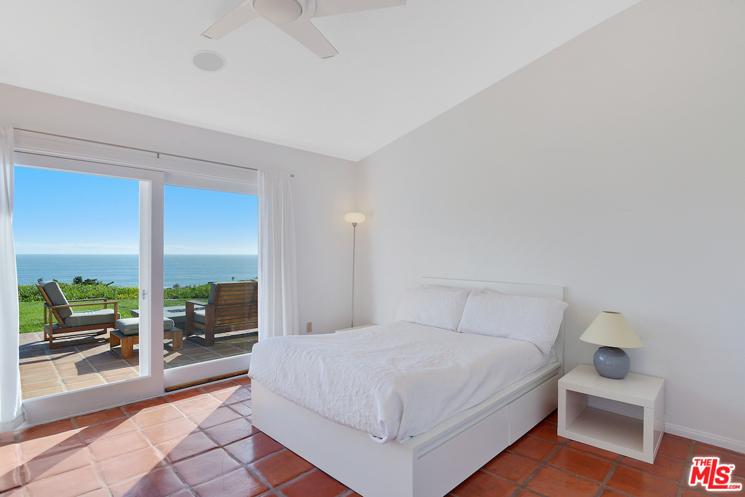 6249 Tapia Drive Malibu, CA 90265 - Photo 15 of 21 a bedroom with a bed and a large window