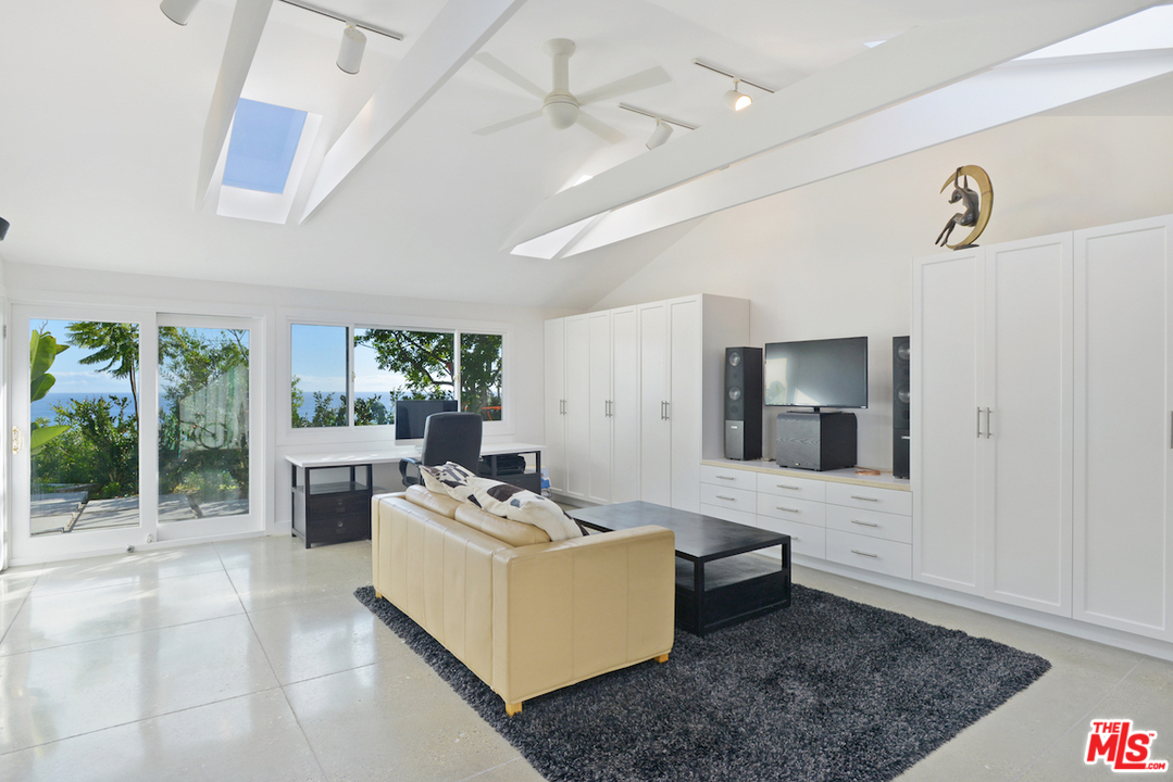 6249 Tapia Drive Malibu, CA 90265 - Photo 16 of 21 a living room with furniture and a flat screen tv