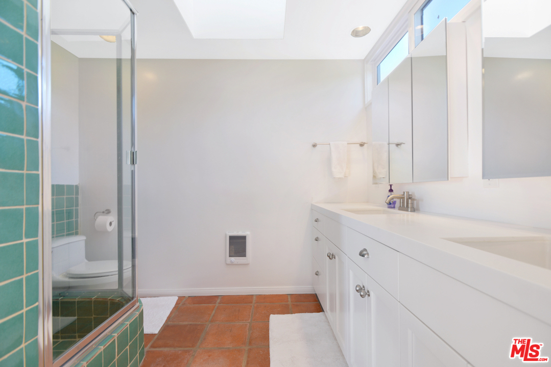 6249 Tapia Drive Malibu, CA 90265 - Photo 17 of 21 a spacious bathroom with a shower and a sink