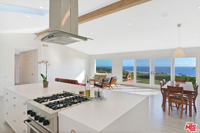 a kitchen with stainless steel appliances granite countertop a stove and a refrigerator
