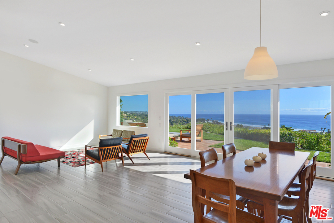 6249 Tapia Drive Malibu, CA 90265 - Photo 9 of 21 a dining room with furniture window and wooden floor