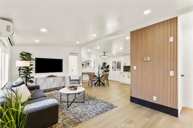 a living room with furniture a rug and a flat screen tv
