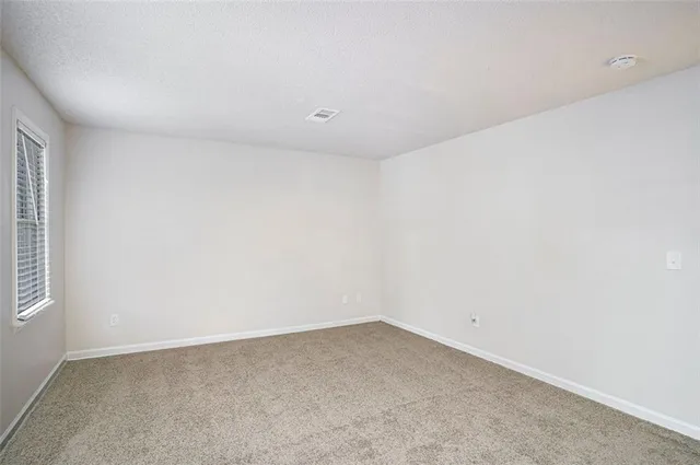 an empty room with a empty space and window