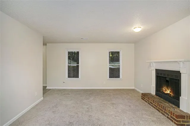 a view of an empty room with a fireplace