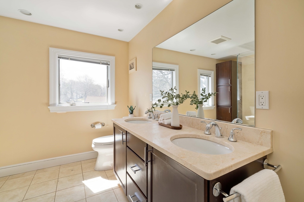 8 Littlefield Road Newton, MA 02459 - Photo 14 of 33 a bathroom with a granite countertop sink and a mirror