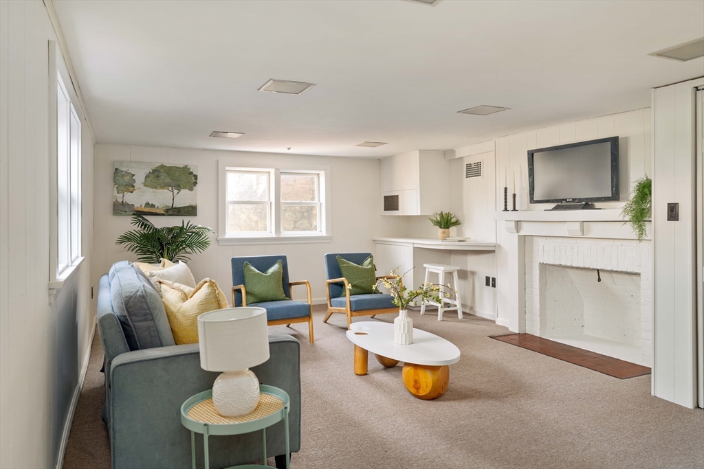 8 Littlefield Road Newton, MA 02459 - Photo 24 of 33 a living room with furniture and a flat screen tv