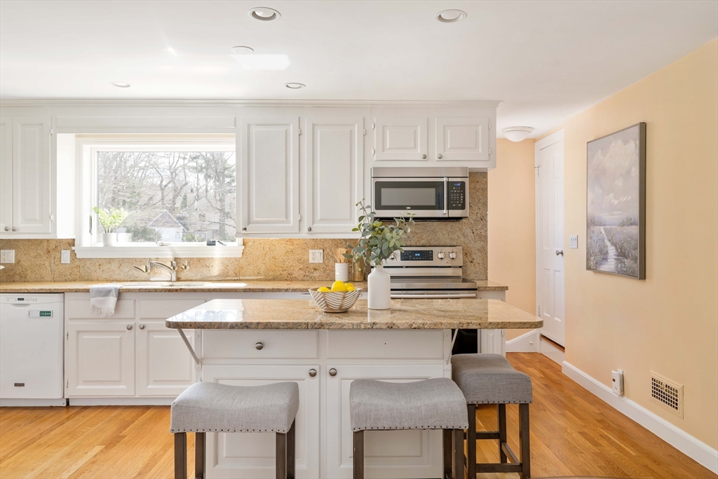 8 Littlefield Road Newton, MA 02459 - Photo 10 of 33 a kitchen with kitchen island granite countertop a sink and cabinets