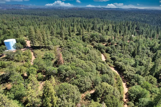 an aerial view of a houses with yard