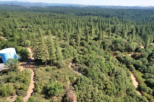 a view of a green field with an outdoor space