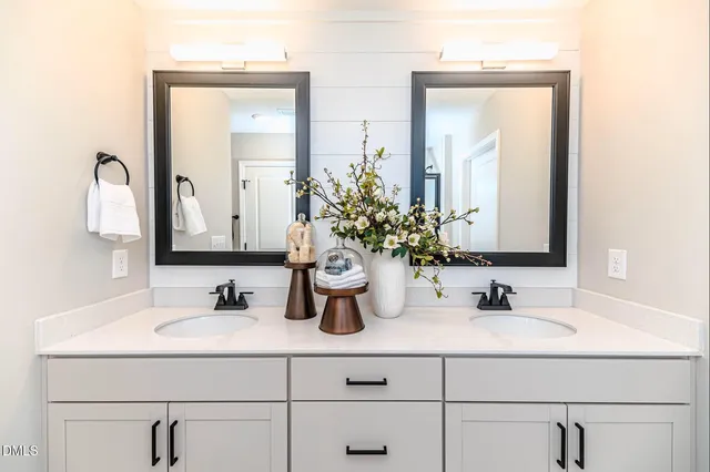 a bathroom with vanity sinks and a mirror