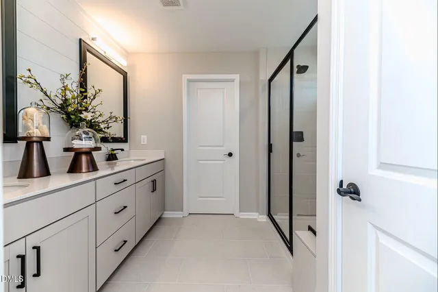 a bathroom with a double vanity sink and mirror