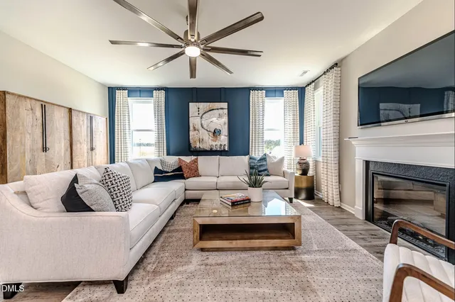 a living room with furniture fireplace and flat screen tv