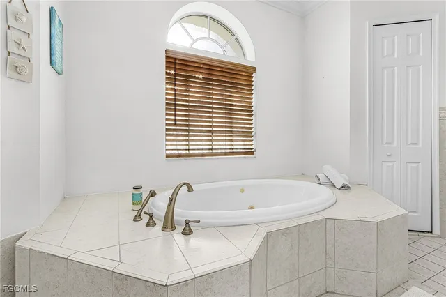 a bathroom with a bathtub and a window