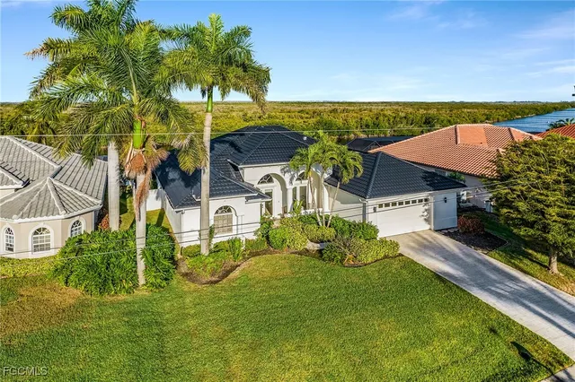 a view of a swimming pool and lounge chairs in patio