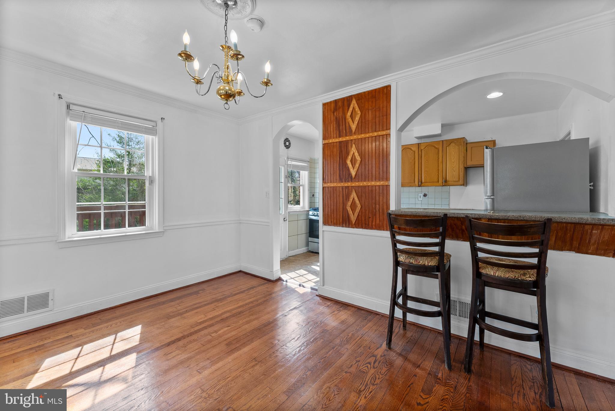 633 Walker Avenue Baltimore, MD 21212 - Photo 11 of 32 a view of a dining room with furniture and chandelier