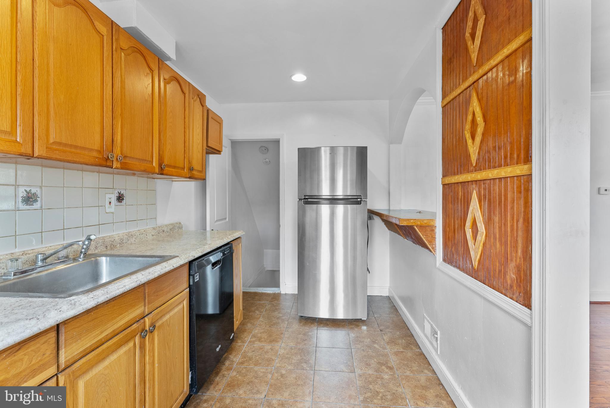 633 Walker Avenue Baltimore, MD 21212 - Photo 4 of 32 a kitchen with a sink and refrigerator