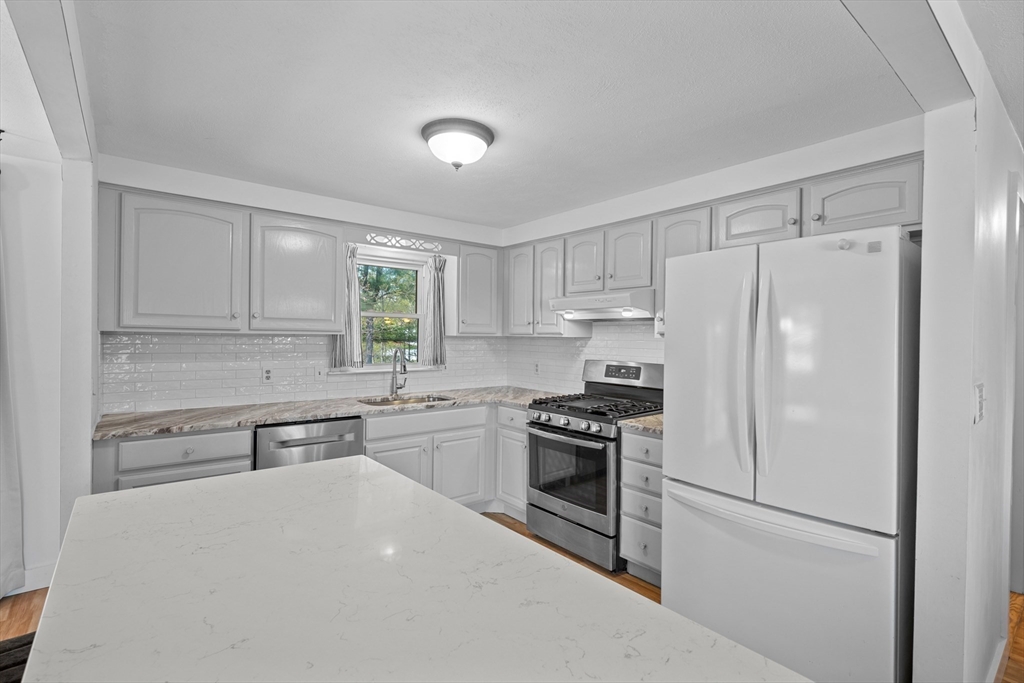 3 Lark Drive Hudson, MA 01749 - Photo 11 of 38 a kitchen with granite countertop a refrigerator stove and sink