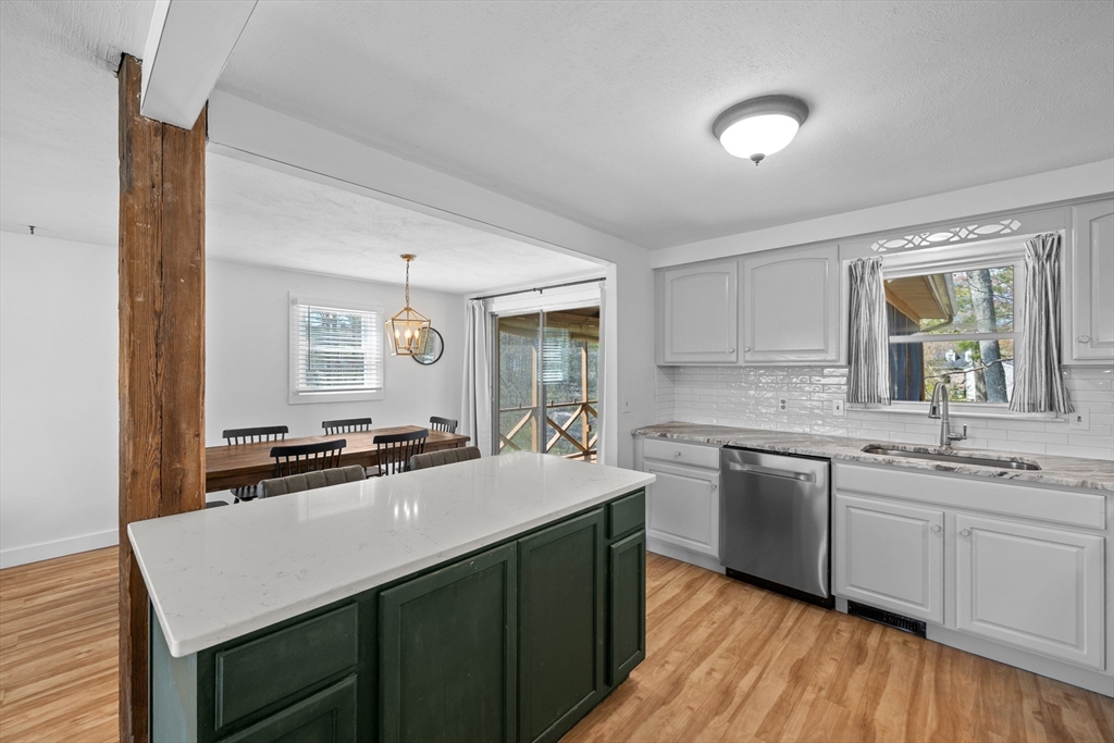 3 Lark Drive Hudson, MA 01749 - Photo 13 of 38 a kitchen with stainless steel appliances granite countertop a sink stove and refrigerator