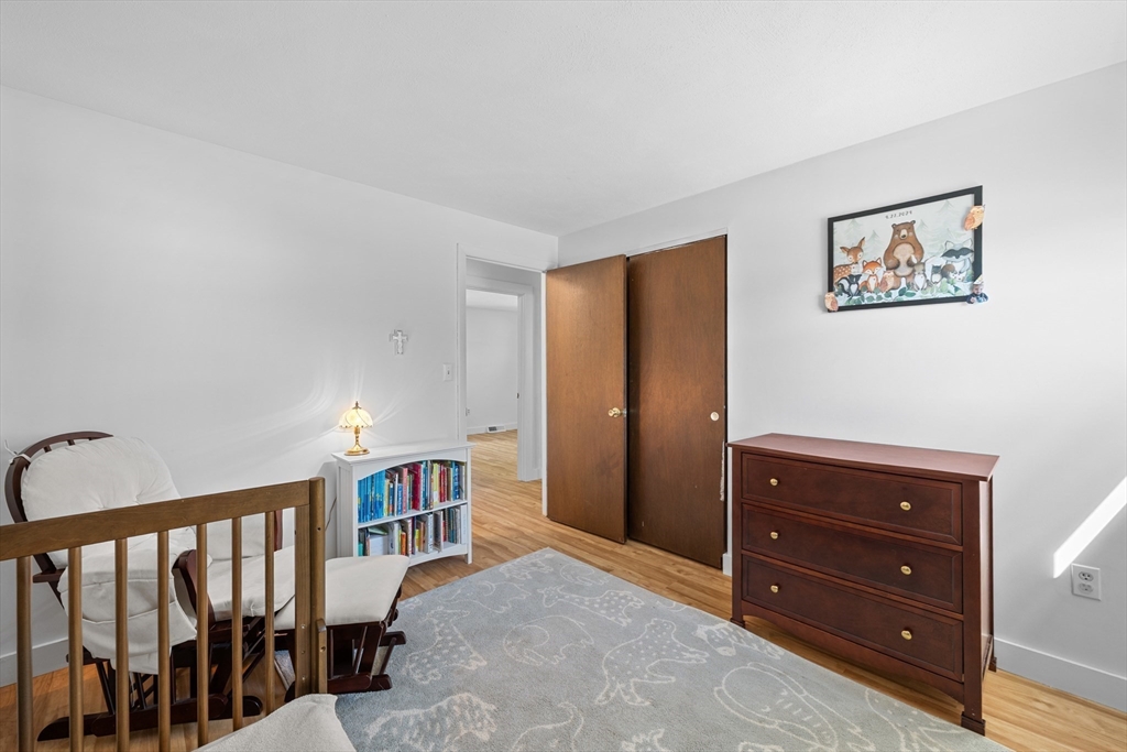 3 Lark Drive Hudson, MA 01749 - Photo 16 of 38 a living room with furniture and a baby crib